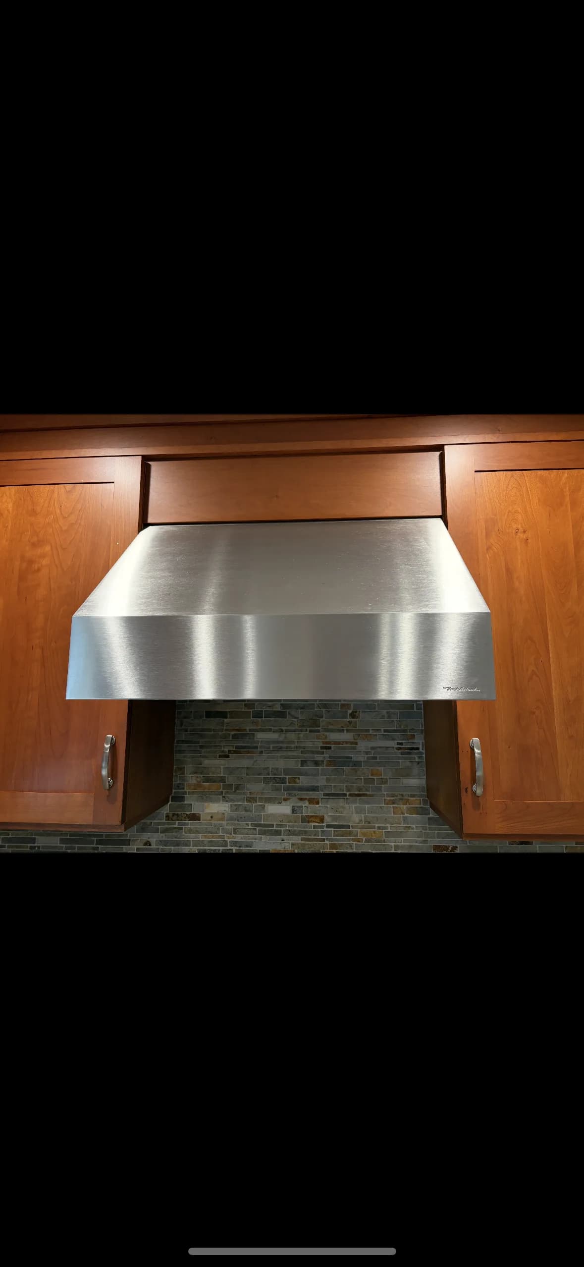 Clean stainless steel residential range hood — Long Island home