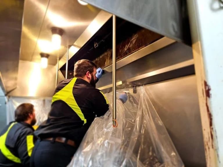 Professional hood cleaning team servicing a commercial kitchen — Long Island